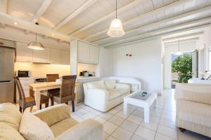 a living room with a couch and a table at Aurora by Mediterra in Isterni