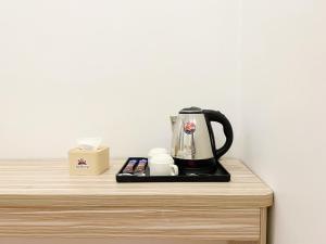 a coffee maker sitting on top of a table at Ah Gong Boutique Bungalows in Sihanoukville