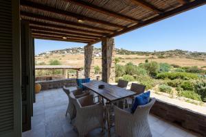 a table and chairs on a patio with a view at Aurora by Mediterra in Isterni