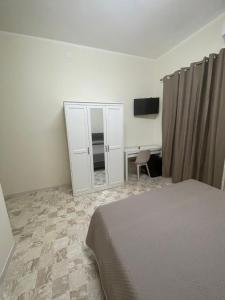 a bedroom with a bed and a dresser and a desk at B&B Dosti in Scafa