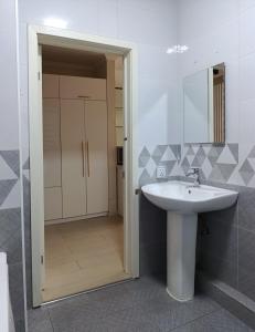 a bathroom with a sink and a mirror at Darkhan Apartment in Darhan +2 photos