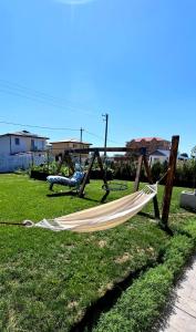 a hammock in a yard with a helicopter at Maracas Sea View Boutiq in Costinesti