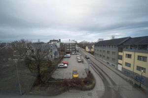 a city street with cars parked in a parking lot at Old Town Reykjavik in Reykjavík
