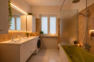 a bathroom with a sink and a washing machine at Villa Vale in Labin +17 photos
