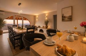 a dining room with a table with food and drinks at Villa Vale in Labin