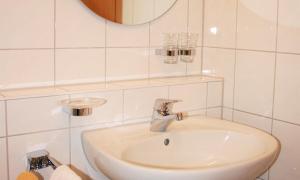 a white bathroom with a sink and a mirror at Sommerhof Rauber in Immenstaad am Bodensee +135 photos