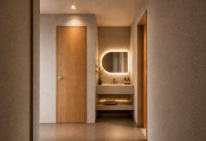 a hallway with a bathroom with a sink and a mirror at Hotel Rima chocolat in Toyohira +87 photos