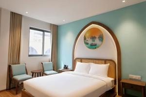 a bedroom with a bed with an arch above it at Sonasea Van Don Letavia Hotel in Thâm Câu +10 photos