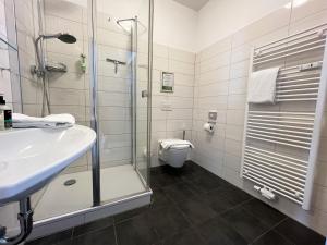 a bathroom with a shower and a sink and a toilet at Hotel Vita Berlin-Messe in Berlin +25 photos