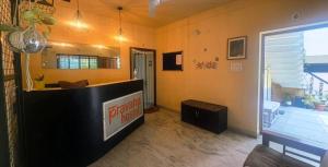 a lobby with a reception desk and a window at Pravaha Hostel in Bangalore