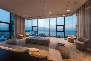 a living room with a couch and large windows at Pattaya Central Excellent 1 Bed Room Unit in Pattaya
