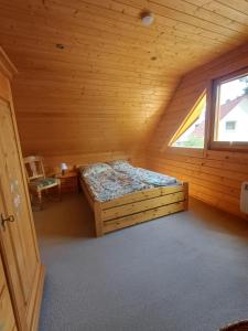 a bedroom with a bed in a log cabin at Holiday Home Fleesensee in Göhren-Lebbin