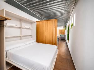 a bedroom with a large white bed in a room at Mirador Torre de la Garrofa in Almería