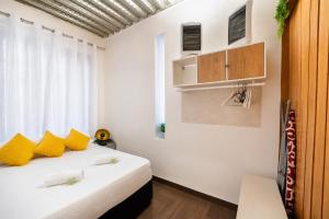 a bedroom with a bed with yellow pillows at Mirador Torre de la Garrofa in Almería +61 photos
