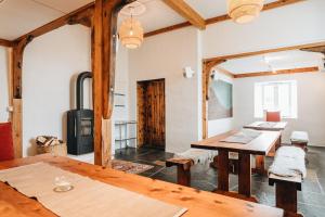 a dining room with a table and a stove at Batalden Ishus in Kinn
