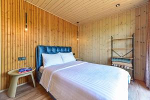 a bedroom with a bed in a wooden wall at Aurora Resort in Stasiūnai