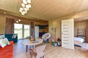 a living room with a couch and a table at Aurora Resort in Stasiūnai +42 photos