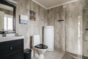 a bathroom with a shower and a toilet and a sink at Batalden Ishus in Kinn +32 photos