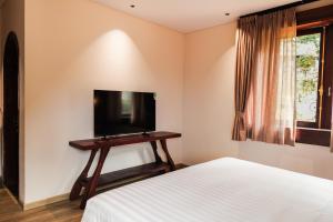 a bedroom with a bed and a tv on a table at ALy's Sapa in Tả Van +55 photos