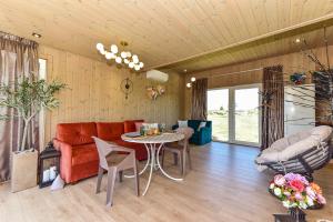 a living room with a couch and a table at Aurora Resort in Stasiūnai