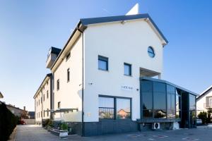 a white building with a lot of windows at Royal Airport Hotel in Velika Gorica