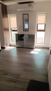 a living room with a dresser and a mirror at White house Residences by Pebbles in Lusaka
