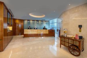a lobby with a reception desk in a building at Ramada Abu Dhabi Corniche in Abu Dhabi +33 photos