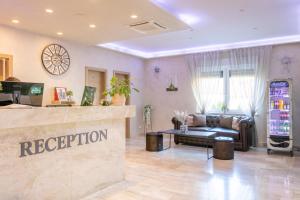 a lobby of a hair salon with a reception counter at Royal Airport Hotel in Velika Gorica