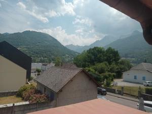 a view of a house with mountains in the background at L'Embaradere in Laruns
