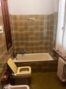 a bathroom with a toilet and a bath tub at I due cipressi in Cagli