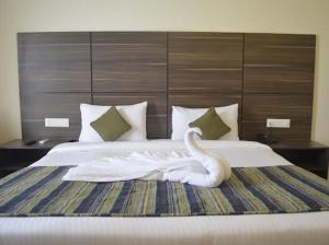 a swan statue sitting on top of a bed at Zentora in Belagula