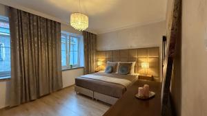 a bedroom with a bed and a table with two lamps at "Na Prostej" Old Town Apartment in Olsztyn