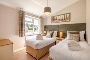 a bedroom with two beds and a window at 3 Bed in York oc-90401 in Riccall