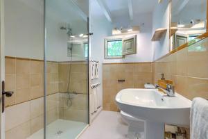 a bathroom with a sink and a shower at Villa Rafaleta by Villa Plus in Pollença +14 photos