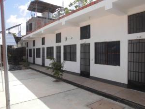 a large white building with black barred windows at Hospedaje Marvento in Pucallpa