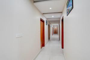 an empty corridor in a hospital with a sign on the wall at Super Townhouse Oak ISBT Bus Terminal Dehradun Formerly Hotel Himalayan in Dehradun