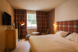 a hotel room with a bed and a window at Hôtel Le Refuge des Sources in Digne-les-Bains +72 photos