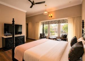 a bedroom with a bed and a large window at Chandralok - A Boutique Hotel in Udaipur Near Fateh Sagar Lake in Udaipur