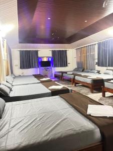 a room with a bunch of beds in it at New Peak By The Lake in Chikmagalūr