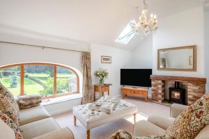 a living room with a couch and a fireplace at 2 Bed in Driffield oc-79279 in Wold Newton