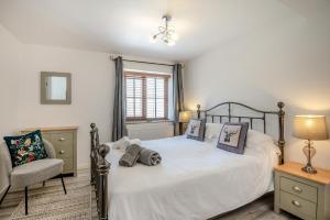 a bedroom with a bed and a chair and a window at 2 Bed in Driffield oc-79279 in Wold Newton