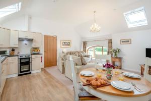 a kitchen and living room with a table and a couch at 2 Bed in Driffield oc-79279 in Wold Newton
