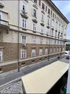 a large building with a large table in front of it at Luxury Marina apartments in Rijeka