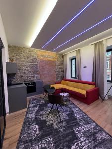 a living room with a red couch and a brick wall at Luxury Marina apartments in Rijeka
