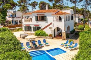 an aerial view of a house with a swimming pool at Villa Gatzara by Villa Plus in Cala Blanca