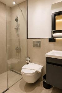 a bathroom with a shower and a toilet and a sink at Bodrum Has Apart Otel in Bodrum City +28 photos