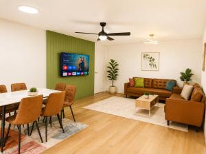 a living room with a table and a couch at Dunes Apartment Unit 8- GROUND FLOOR WITH POOL VIEW in Coffs Harbour