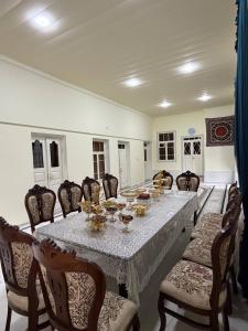 a large dining room with a long table and chairs at Aziz Guest House in Samarkand