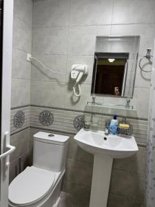 a bathroom with a toilet and a sink at Aziz Guest House in Samarkand