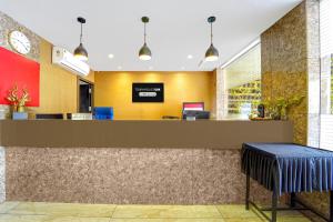 a lobby of a store with a reception counter at Townhouse Oak Kozhikode Bus Stand Formerly Nextel Inn in Kozhikode